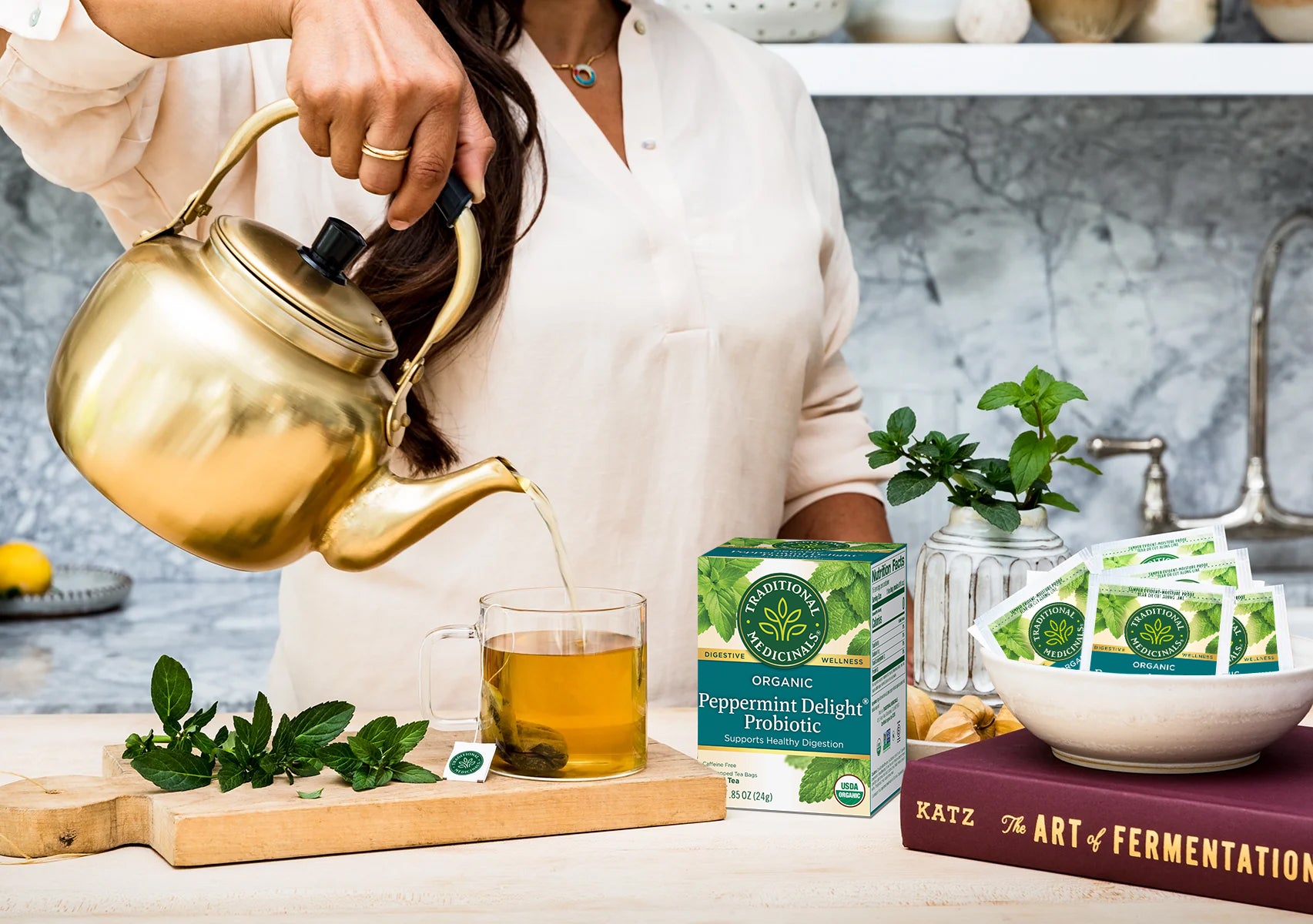 Peppermint Delight Probiotic box and tea being poured from gold teapot