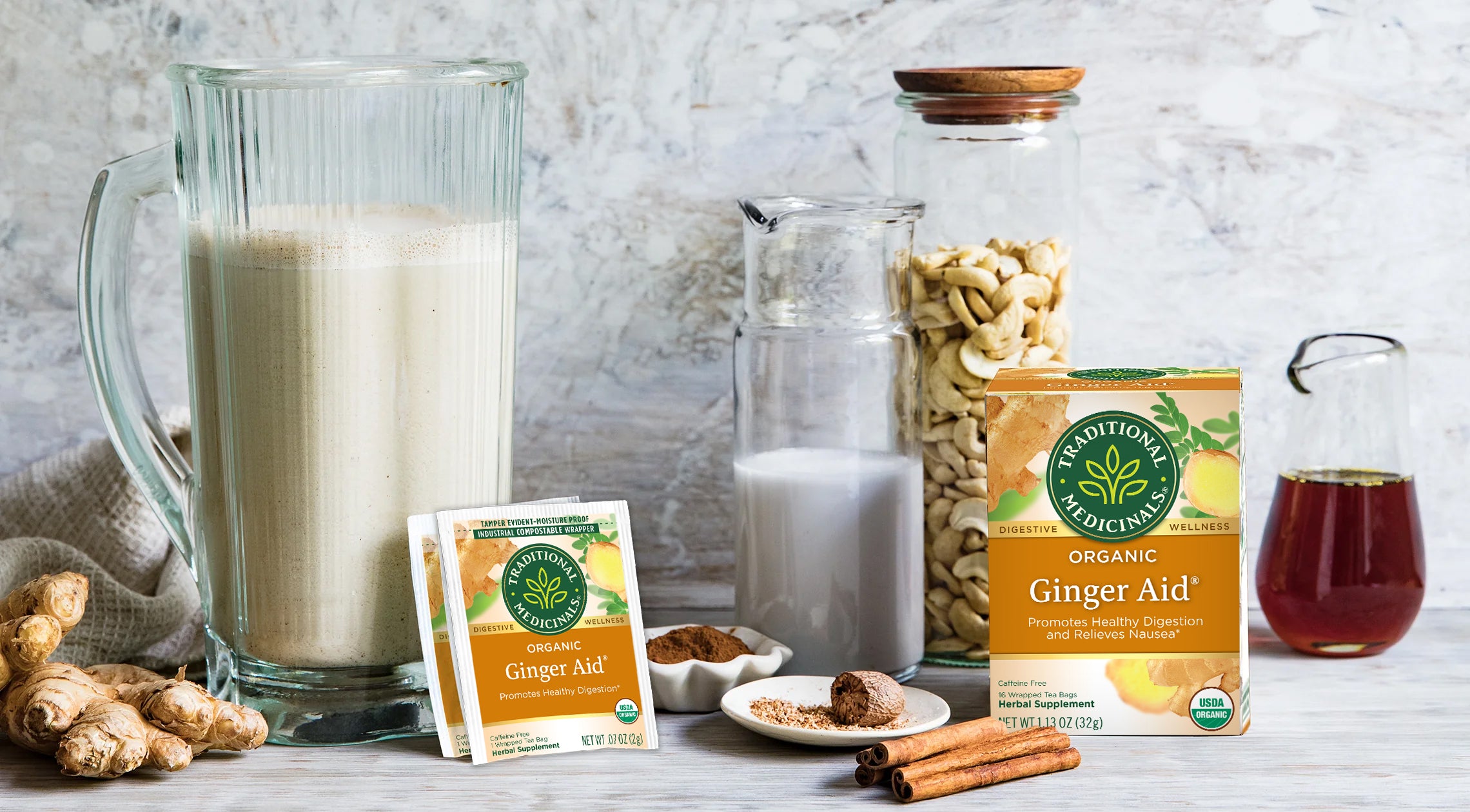 Ginger Aid Organic Tea packaging with eggnog in a pitcher and ingredients